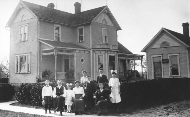 Alois J. Willke Family in 1916. Front of hedge row: L-R: Al, Alois, Marcella, Caroline, Edgar, Tanta & Lucille. Behind hedge row standing L-R: Marie & George Willke. The house and  doctor's office (right) was built was in 1900. The address of this house is 8459 OH-119, Maria Stein, OH 45860. This became the home of Edgar and Alfrida (Kleinhenz) Willke where they raised four children.